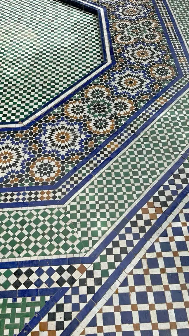 Close view of Moroccan zellige tile geometry and fountain edge