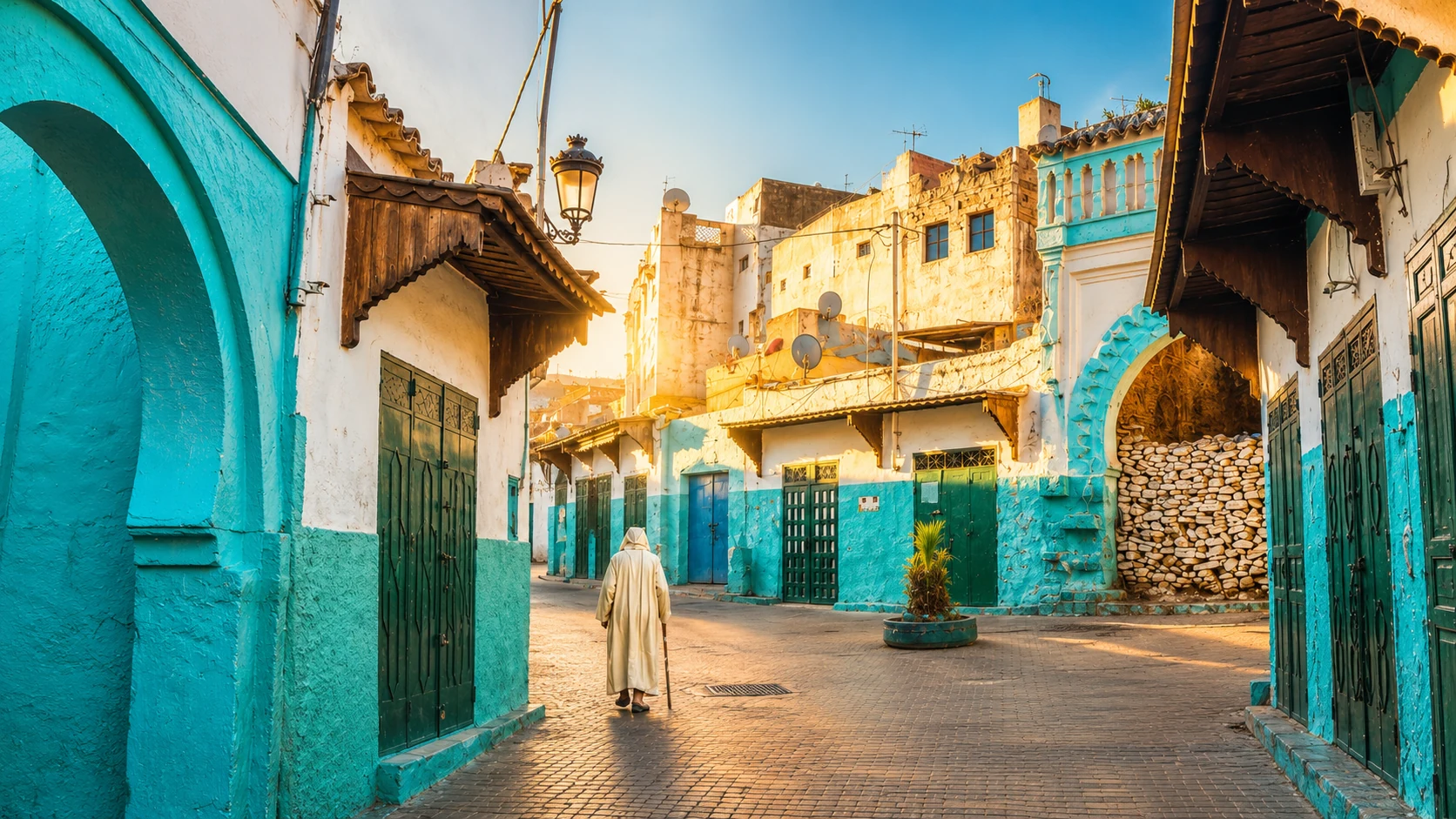 Turquoise and white medina street in Ouazzane at golden light