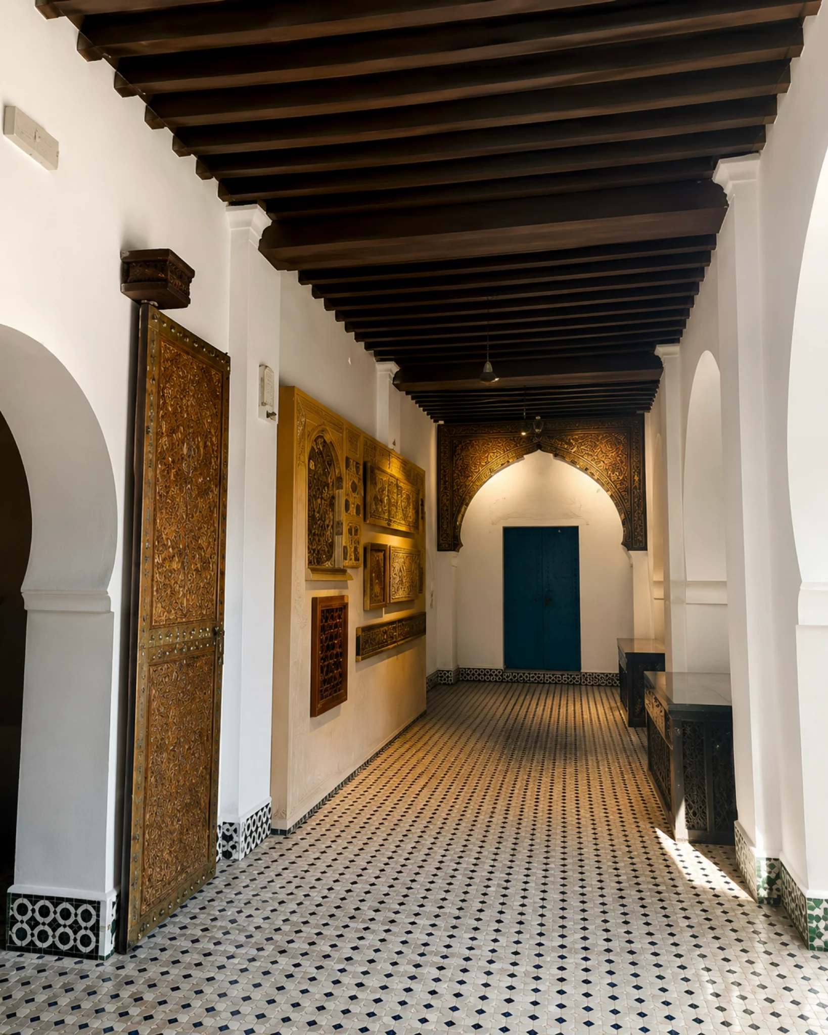 Carved wood display and tiled corridor in Tétouan