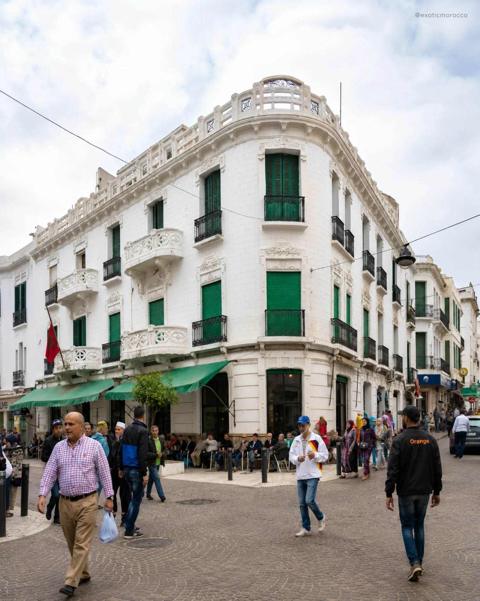 White Ensanche building with green shutters in Tétouan